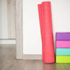 Colorful yoga blocks and mat arranged in a cozy indoor space perfect for practice